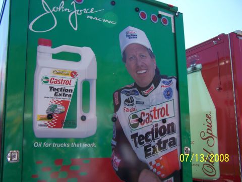 1972 Ford Ranchero - A racing truck features a large graphic of John Force and an advertisement for Castrol Taction Extra motor oil.