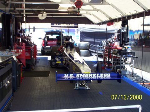 1972 Ford Ranchero - Dragster and support SUV in a pit area, with tools and equipment visible.