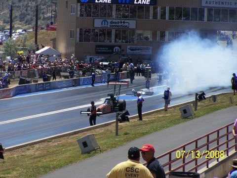 1972 Ford Ranchero - A drag racing car is on the track, generating a large cloud of smoke during an event.