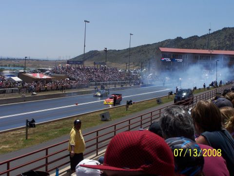 1972 Ford Ranchero - Drag racing event with multiple cars on the track and a large crowd in the stands.