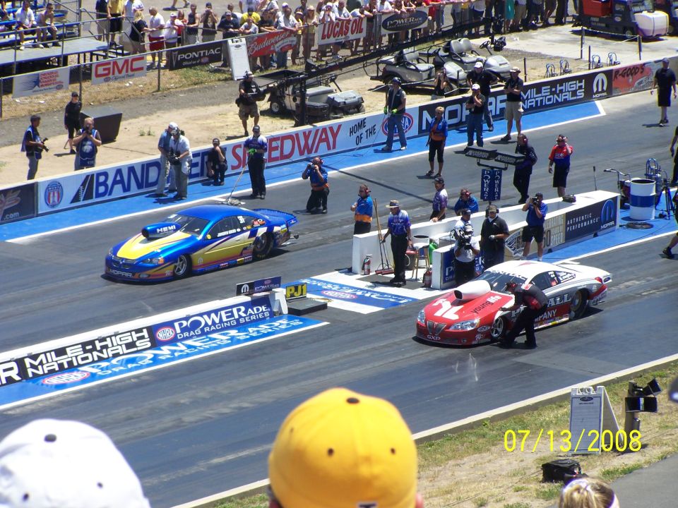 Drag racing cars on track with spectators and date 07/13/2008