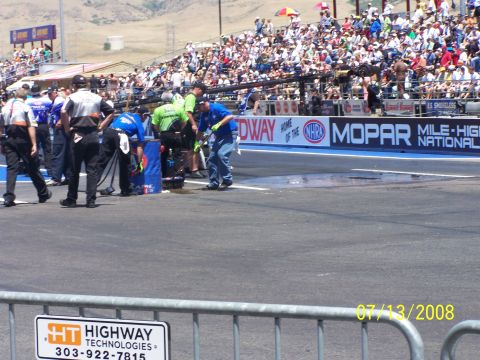 1972 Ford Ranchero - A drag strip scene with crew members on the track and spectators in the stands, dated 07/13/2008.