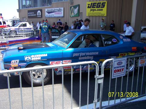 1972 Ford Ranchero - A 1972 Ford Ranchero drag car displays numerous sponsor decals at a race track event.