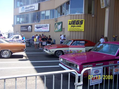 1972 Ford Ranchero - Three drag cars are lined up at Bandimere Speedway, with the pink car in the foreground showing NHRA and date markings.