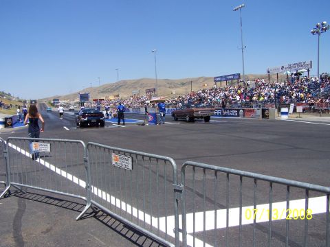 1972 Ford Ranchero - Drag racing event with cars lined up and a crowd watching from the stands.