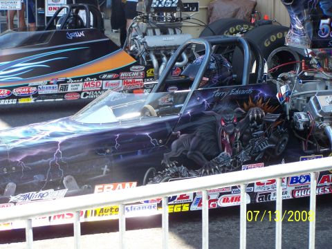 1972 Ford Ranchero - Two dragsters are parked side-by-side, one with a custom monster paint job.