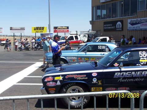 1972 Ford Ranchero - Drag cars line up at Bandimere Speedway on a sunny day, with spectators in the background.