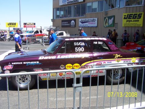 1972 Ford Ranchero - A purple drag car, identified as "SS/GA 590" and marked "FOR SALE", is covered in numerous racing decals and sponsorships.