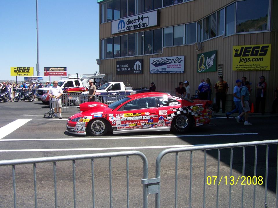 Red drag car covered in stickers, parked at a drag strip. Date stamp reads 07/13/2008
