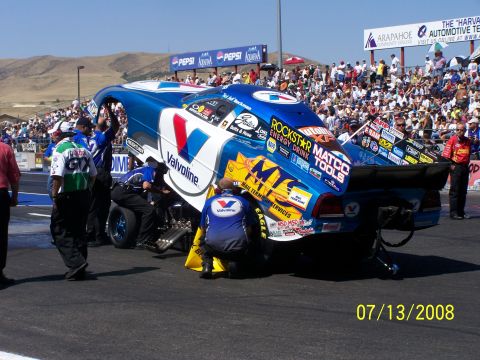 1972 Ford Ranchero - Drag racing car with crew members making adjustments on the track at Bandimere Speedway.
