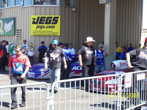 1972 Ford Ranchero - A scene at a drag strip with multiple race cars and crew members, including a JEGS banner in the background.