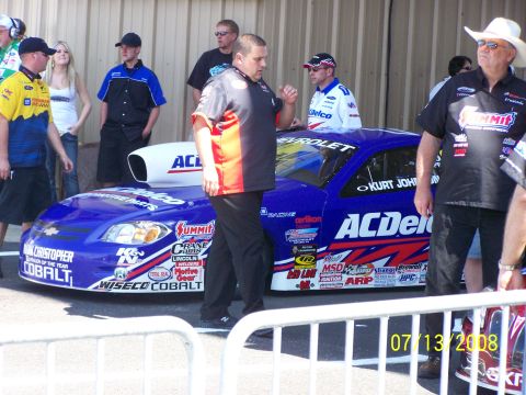 1972 Ford Ranchero - A blue ACDelco sponsored drag racing car with "Kurt Johnson" on the door is seen with crew members.