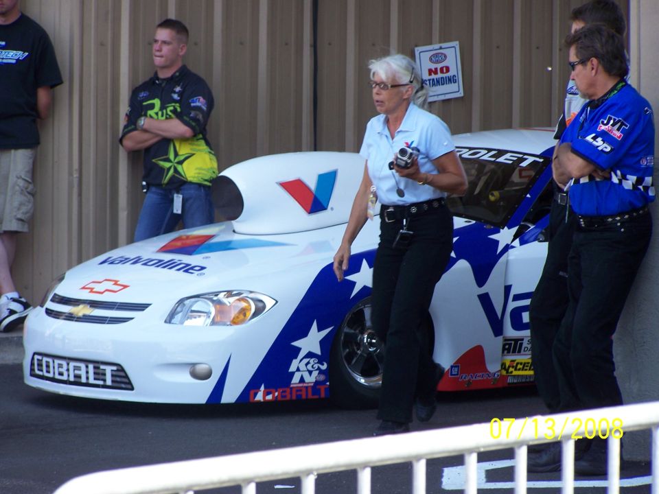 White drag racing car with blue stars and Valvoline livery, showing 'COBALT' on the front bumper