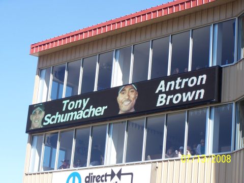 1972 Ford Ranchero - A building displays a digital billboard with photos and names of Tony Schumacher and Antron Brown.