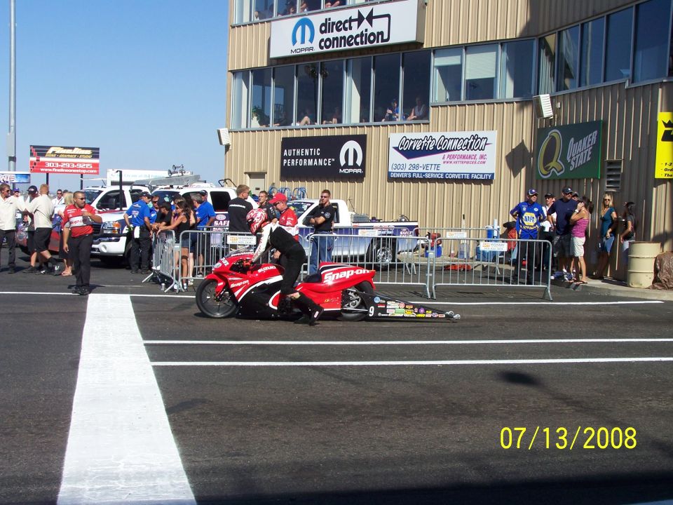 Drag racing motorcycle with Snap-on logos on the side, being prepared on a track