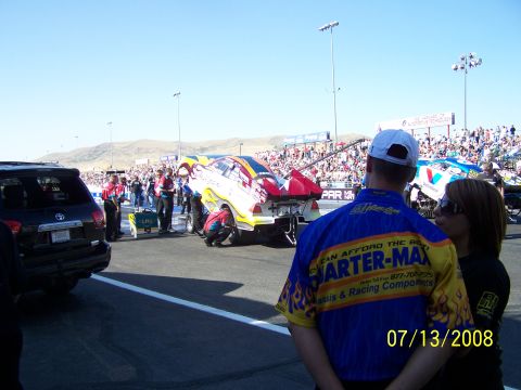 1972 Ford Ranchero - Drag racing event with multiple cars and crew members preparing on the track.