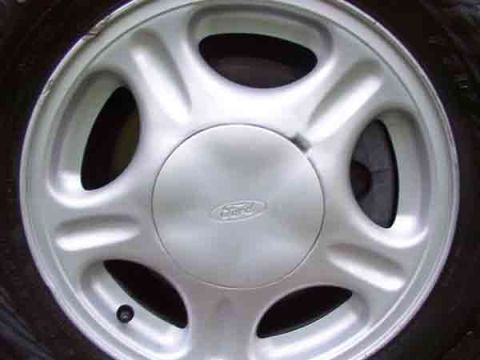 1998 Ford Taurus - Silver Ford wheel shown up close, likely from a sedan or SUV.
