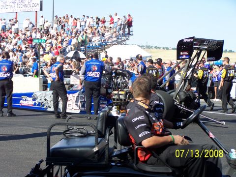 1972 Ford Ranchero - A dragster with "Matco Tools" branding is on the track, surrounded by pit crew members and a large crowd in the stands.