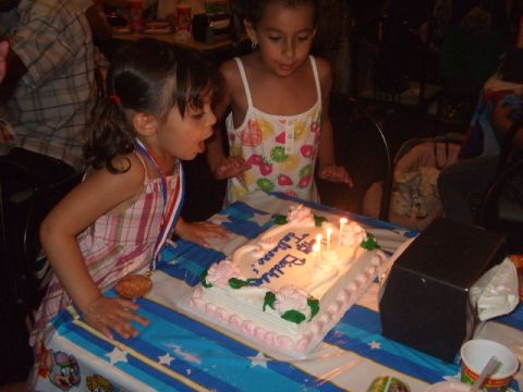 2008 Jeep Cherokee - Children celebrate a birthday by blowing out candles on a decorated cake.
