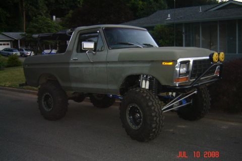 1978 Ford Bronco - This modified 1978 Ford Bronco features a significant lift, aggressive off-road tires, and a custom front bumper with auxiliary lights.