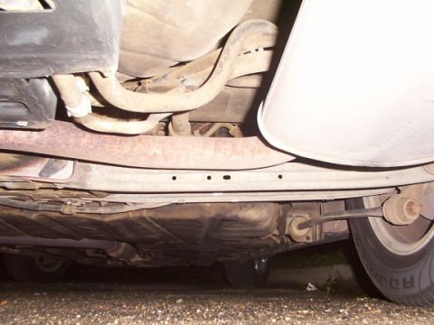 1998 Ford Taurus - The underside of a 1998 Ford Taurus reveals its exhaust system and fuel tank components.