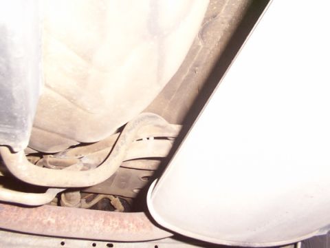 1998 Ford Taurus - Close-up of the exhaust system, focusing on pipes and the muffler area.