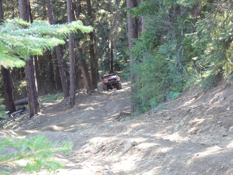 John on the hill climb, no that is not a winch cable.
Looks like a stick in the foreground.