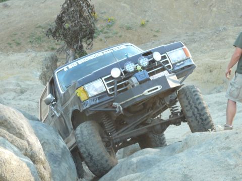 1991 Ford Bronco - Ford Bronco tackling difficult terrain on an off-road trail.