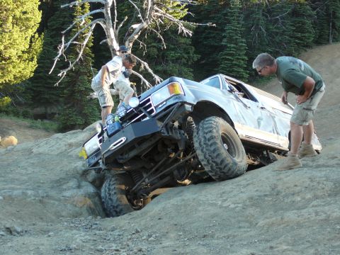 1991 Ford Bronco - This 1991 Ford Bronco tackles a challenging off-road obstacle with assistance from onlookers.