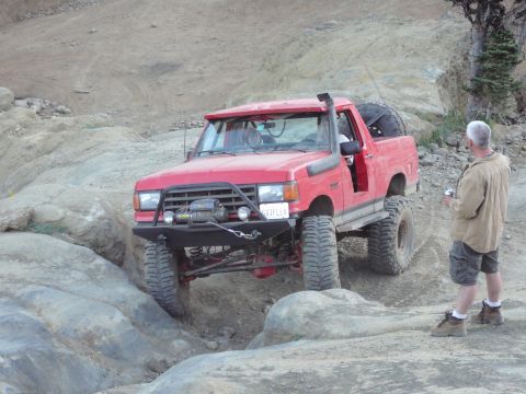 1991 Ford Bronco - Red 1991 Ford Bronco tackling an off-road obstacle course.