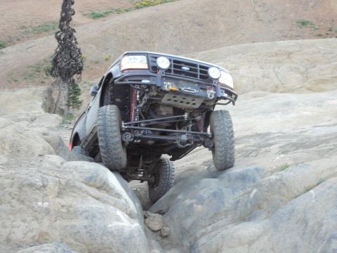 1991 Ford Bronco - This modified Ford Bronco navigates a challenging rocky terrain, its off-road capabilities.