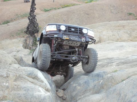 1991 Ford Bronco - A modified 1992 Ford Bronco navigates a rocky trail during an off-road event.