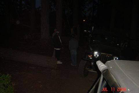 1978 Ford Bronco - Nighttime scene with a Jeep Wrangler and several people gathered around.