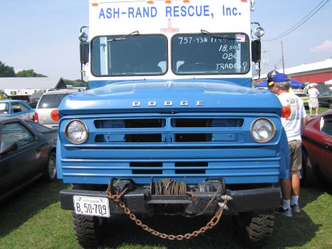 2001 Ford Crown Victoria - Blue Dodge truck with winch and chain, ASH-RAND RESCUE, Inc. text visible on cab.