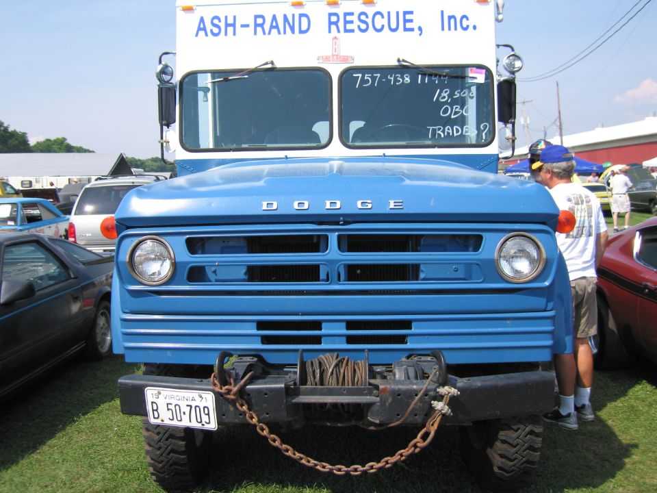 Front view of a blue Dodge truck with a winch and chain, license plate B.50-709. ASH-RAND RESCUE, Inc. text on top