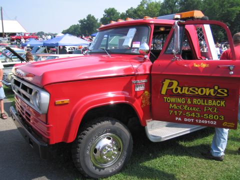 2001 Ford Crown Victoria - This red tow truck displays "Parson's Towing & Rollback" along with contact information on its open door.