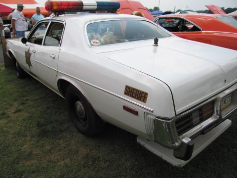 2001 Ford Crown Victoria - This police car features a "SHERIFF" decal and a light bar, with another vehicle parked nearby.