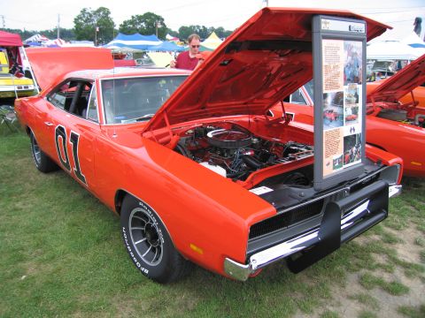 2001 Ford Crown Victoria - This iconic orange Dodge Charger, often recognized as the "General Lee", is displayed with its hood open, revealing the engine.