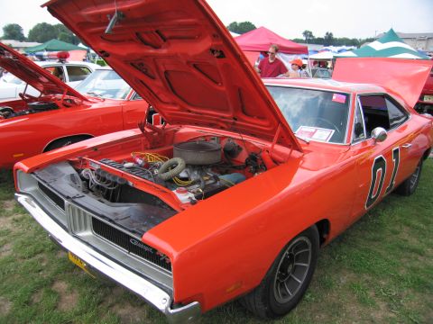 2001 Ford Crown Victoria - A 1969 Dodge Charger, famously known as the General Lee, is displayed with its hood open at an outdoor event.