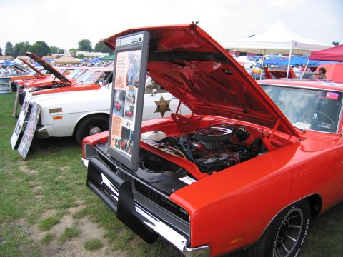2001 Ford Crown Victoria - A classic muscle car is displayed with its engine exposed at an outdoor car show.