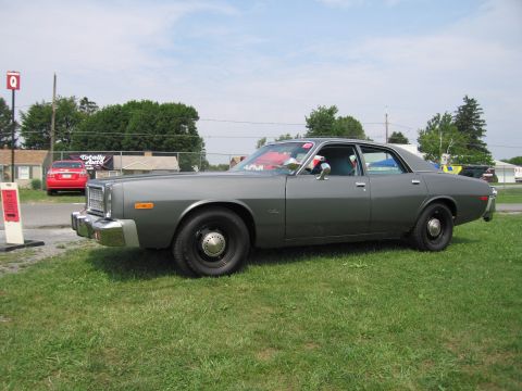 2001 Ford Crown Victoria - Side view of a 1977 Dodge Monaco sedan with a gray paint job and black wheels.