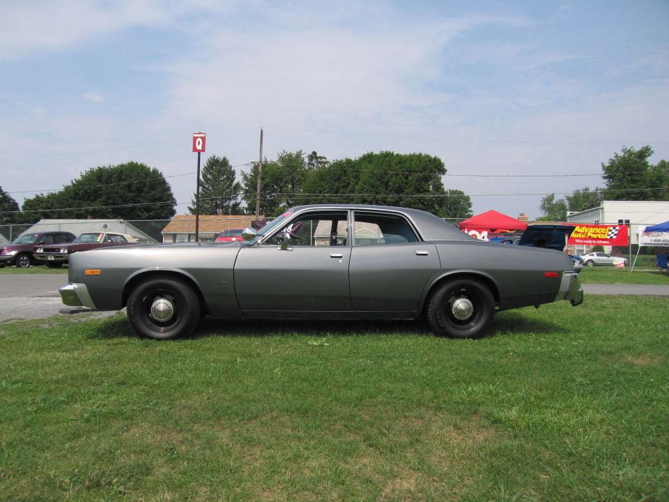 Gray 1970s Dodge Monaco sedan parked on grass