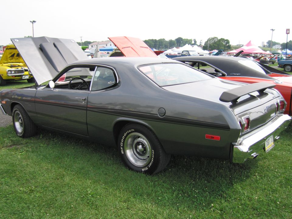 Gray 1975 Dodge Dart Sport with hood open, parked on grass