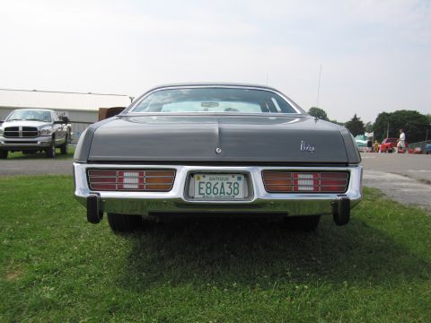 2001 Ford Crown Victoria - The rear of a classic Dodge sedan is shown, with a chrome bumper and distinctive taillights.