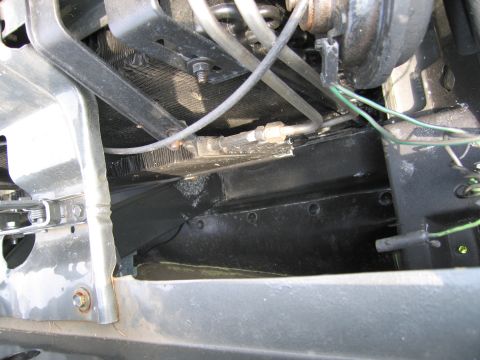 2001 Ford Crown Victoria - Detail shot of engine bay components, including the radiator and various hoses and wires.