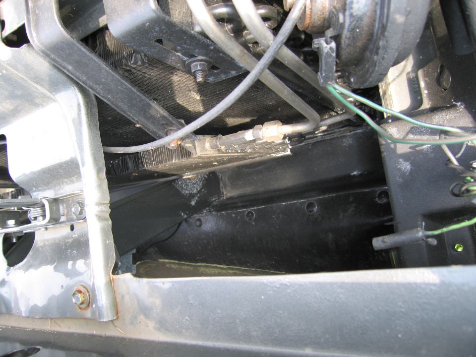 Close-up of radiator, hoses, and wiring in a vehicle's engine bay