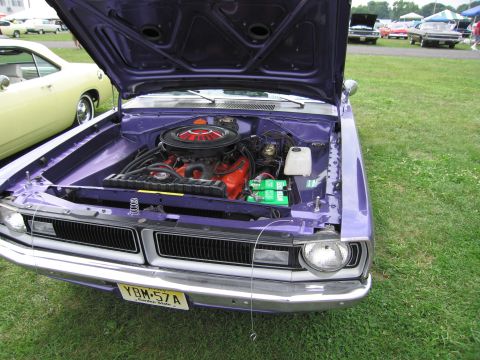 2001 Ford Crown Victoria - A purple 1970 Dodge Dart is parked on grass with its hood open, revealing the engine bay.