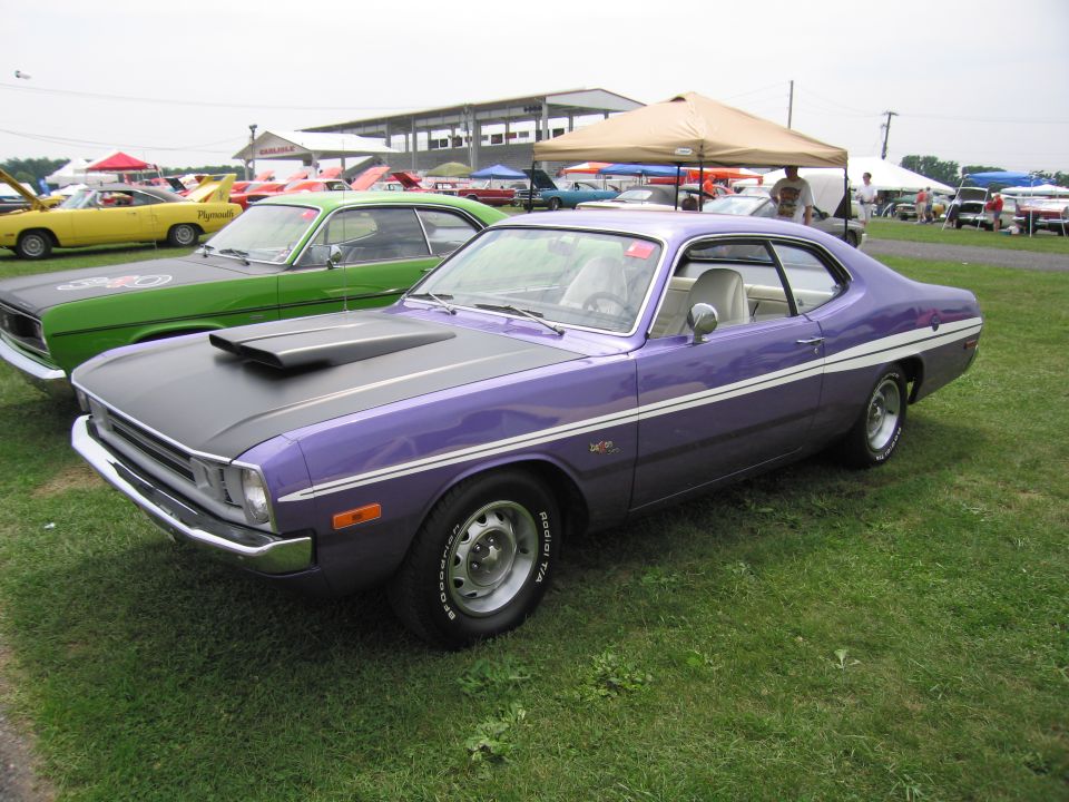 Purple Dodge Dart with black hood scoop and white stripe