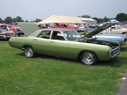 2001 Ford Crown Victoria - Photograph of a green Dodge sedan with open hood, not a technical document.
