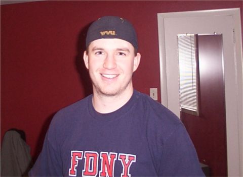 1998 Ford Taurus - Man wearing FDNY t-shirt and WVU cap indoors.